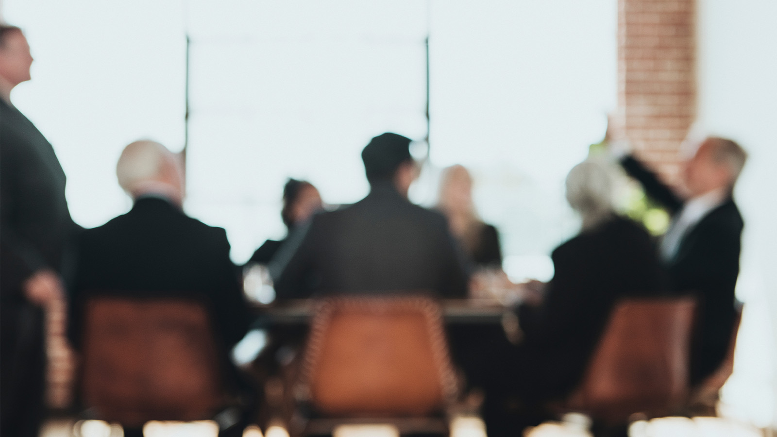 An out-of-focus photo of a corporate boardroom