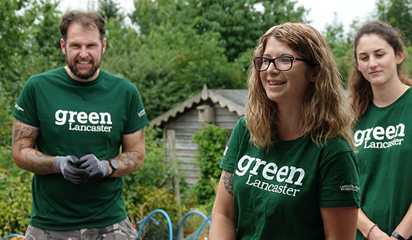 Volunteers working outdoors wearing Green Lancaster t-shirts